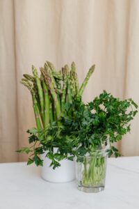 Asparagus in a cup and parsley in a jar 