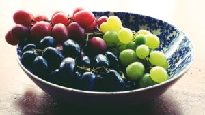 Article: Companion Plants for Grapes. Pic -three colors of grapes in a bowl