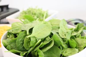 Article: Spinach companion plants. spinach leaves in a bowl