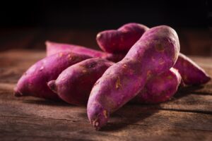 Purple sweet potatoes on a chopping board
