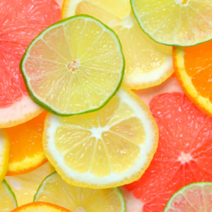  Close-up of thinly sliced citrus fruits, including lime, lemon, orange, and grapefruit, overlapping each other.