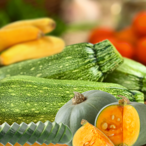 Article: Companion Planting Cucumbers. Pic - A collection of cucumbers, zucchini, and yellow squash arranged on a table, showcasing their vibrant colors and textures.
