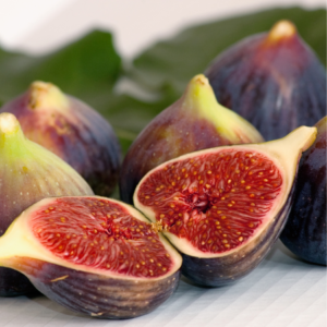 Close-up of fresh figs, with one fig cut in half to reveal its juicy red interior and seeds.