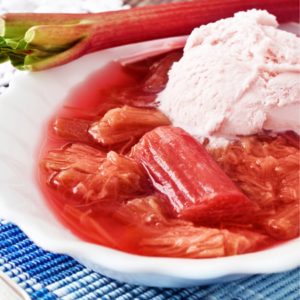 Article: Rhubarb Companion Plants. Pic - A bowl of stewed rhubarb with a scoop of strawberry ice cream.
