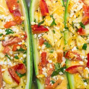 Article; Grow Your Own Low-Oxalate Foods. Pic - Close-up of baked stuffed zucchinis filled with a mixture of cheese, tomatoes, and herbs.